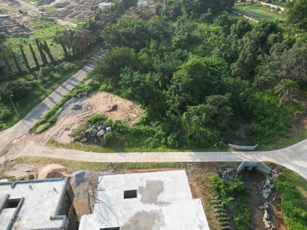 Concrete footpath winding through green landscaping at Maitama Amusement Park