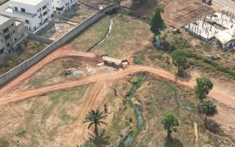 Drainage channel and retaining wall beside open land in Maitama
