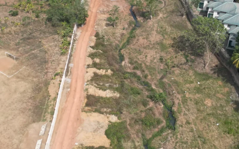 Eroding gully beside a boundary wall that needs drainage