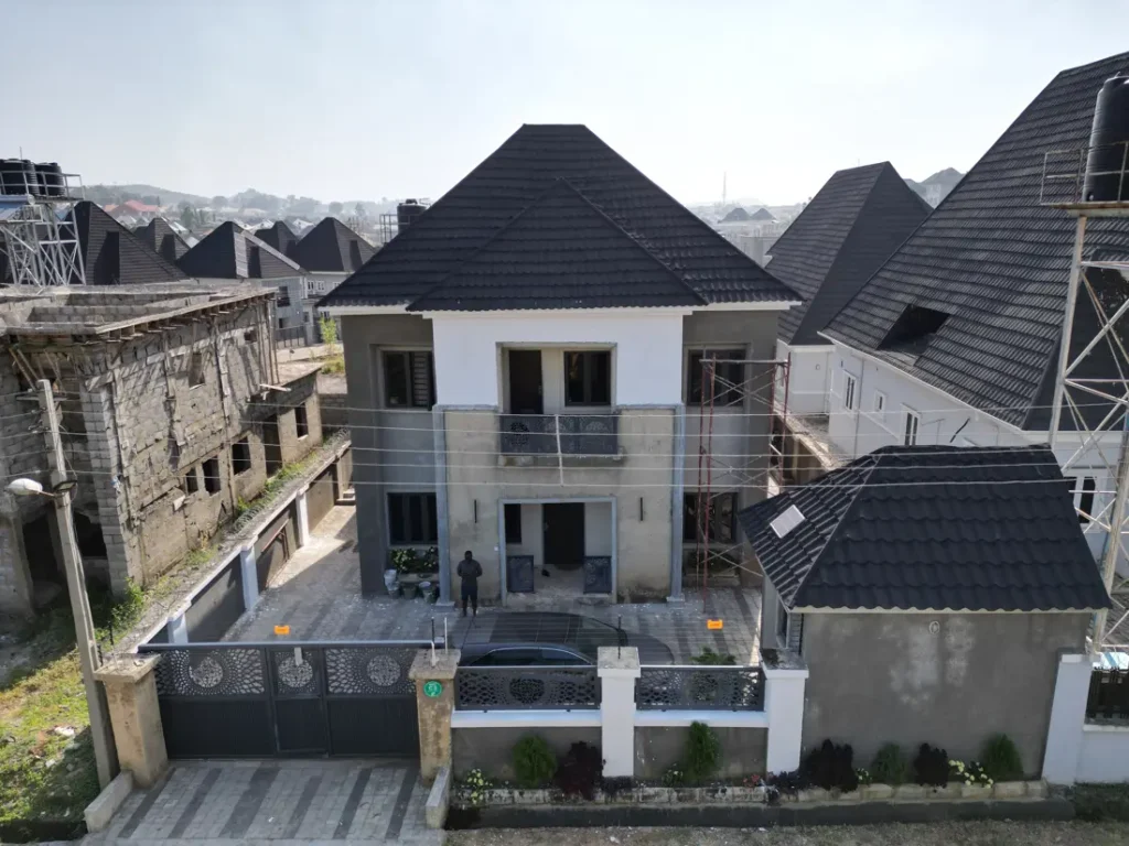 Modern house with a tiled roof and perimeter wall in an estate