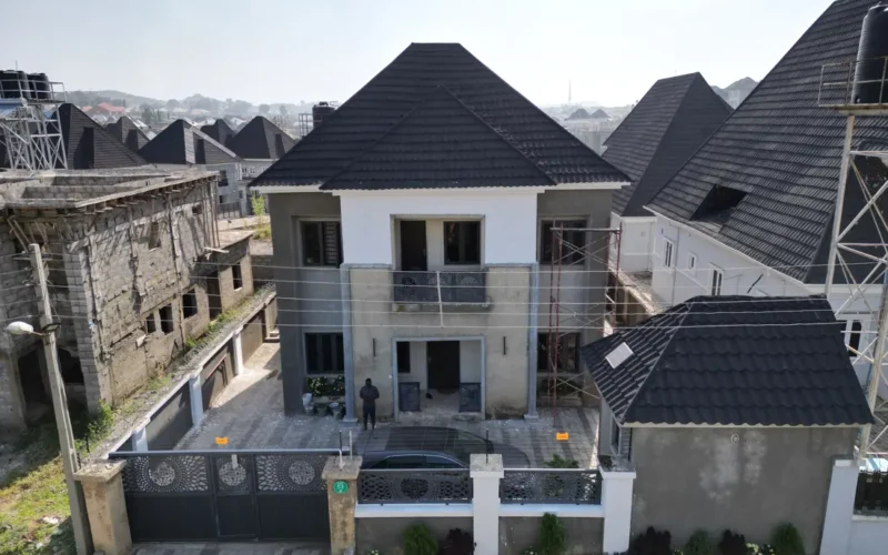 Modern house with a tiled roof and perimeter wall in an estate