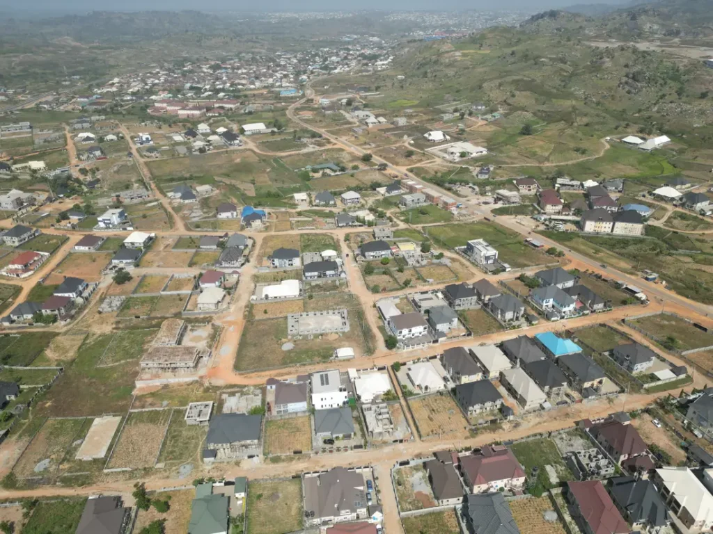 Aerial view of a housing estate with roads and homes in Abuja